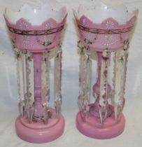 A pair of Victorian pink tinted glass table lustres with painted decoration and glass lozenge