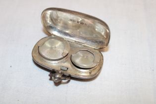 An Edward VII silver oval double sovereign case with interior fitting for sovereigns and half