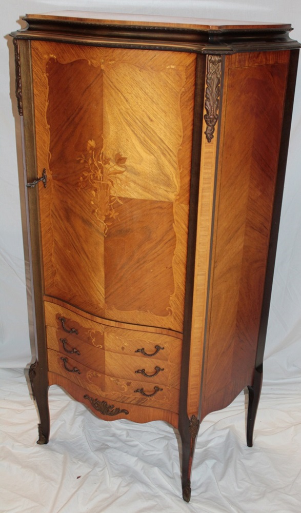 A French Kingwood side cabinet with shelves enclosed by a central door above three small drawers