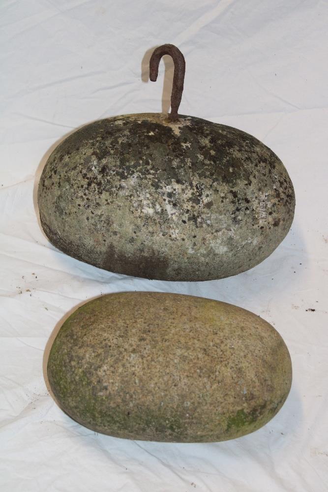 A Cornish granite oval pilchard pressing stone/boat anchor with iron bracket,