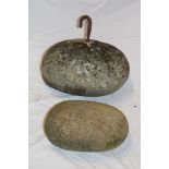 A Cornish granite oval pilchard pressing stone/boat anchor with iron bracket,