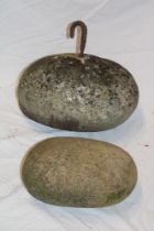 A Cornish granite oval pilchard pressing stone/boat anchor with iron bracket,