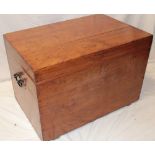 An old polished elm rectangular trunk with hinged lid and iron ring handles,