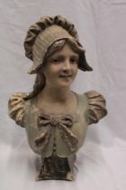 A Continental painted plaster bust figure of a female wearing a bonnet,