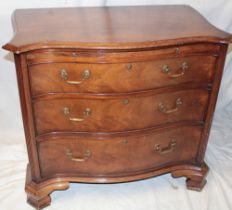 A good quality mahogany serpentine fronted chest of three long drawers with brushing slide on