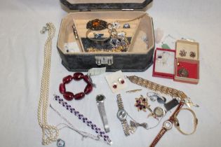A jewellery box containing a quantity of various costume jewellery including necklaces,