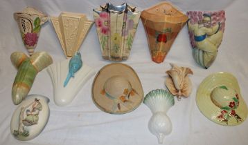 A collection of twelve various pottery wall pockets including Art Deco wall pockets, hat pockets,