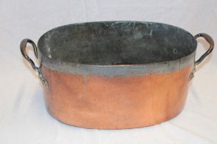 A large Victorian copper oval two-handled cooking pan,