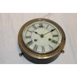 A ship's-style cylindrical wall clock with painted circular dial in brass mounted case,