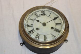 A ship's-style cylindrical wall clock with painted circular dial in brass mounted case,