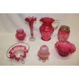 A selection of Victorian and later cranberry tinted glass ware including tapered spill vase,