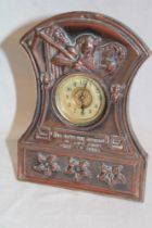 A copper mounted desk clock decorated in relief with Father Time "So Runs the Round of Life from