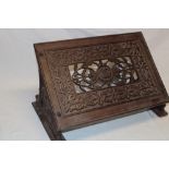 An old cast-iron lectern-style reading/book-stand with pierced and raised decoration,