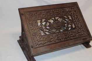 An old cast-iron lectern-style reading/book-stand with pierced and raised decoration,