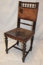 An unusual 19th century carved oak occasional chair with embossed leather seat and back pad on
