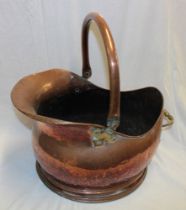 A large old copper coal helmet with swing handle