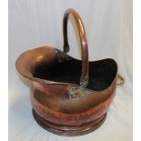A large old copper coal helmet with swing handle