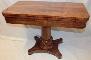 A Victorian rosewood rectangular turn-over-top card table on tapered column with plateau base,