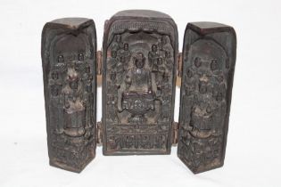 An old Eastern carved wood folding shrine depicting Buddha figures and characters, signed,