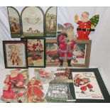 A selection of vintage Christmas adverts and decorations including pressed card figures of Father