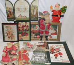 A selection of vintage Christmas adverts and decorations including pressed card figures of Father