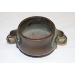 A small 19th century Japanese bronze circular two-handled incense pot,