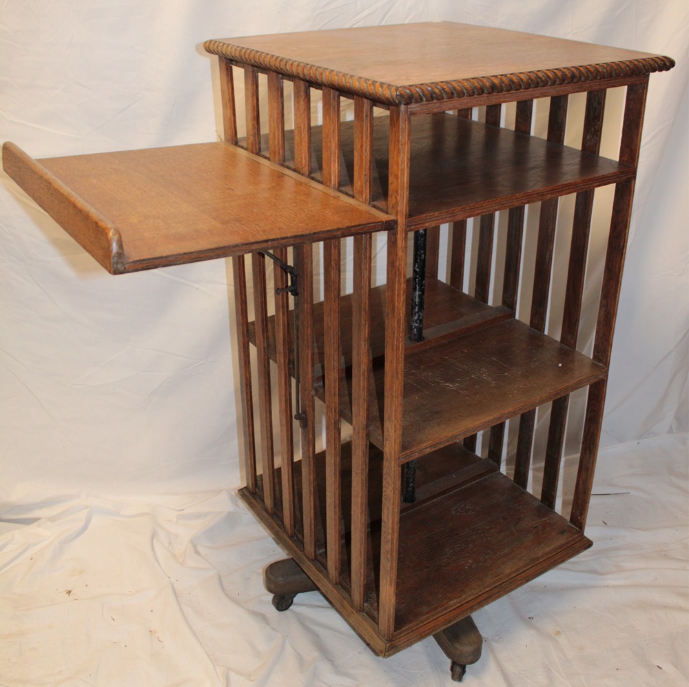 A late Victorian oak square revolving book stand with attached folding reading stand,