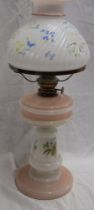 A Victorian opaque glass oil lamp with floral decorated stem and similar opaque glass shade