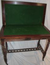 A 19th century walnut rectangular turn-over-top card table with baize lined playing surface on