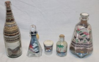 Five bottles and flasks containing sand decoration