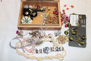A jewellery box containing a quantity of various costume jewellery including necklaces, earrings,