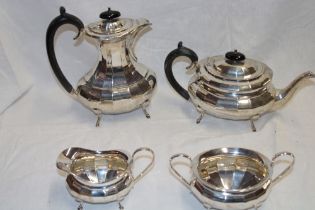 A George V silver four-piece tea and coffee set comprising an oval balluster-shaped coffee pot with