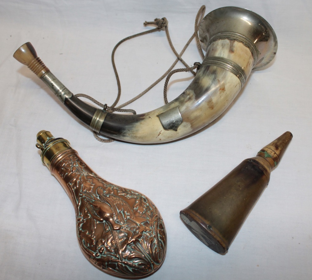 A 19th century brass mounted copper powder flask by Hawksley with dead game decoration,