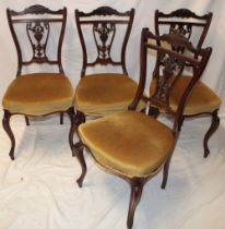A set of four Victorian carved mahogany dining chairs by T. Wallis & Co.
