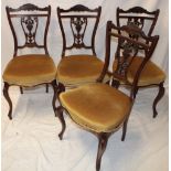 A set of four Victorian carved mahogany dining chairs by T. Wallis & Co.