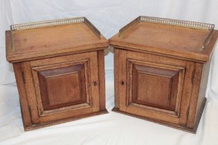 A pair of walnut collector's-style table chests of three small drawers enclosed by a hinged door