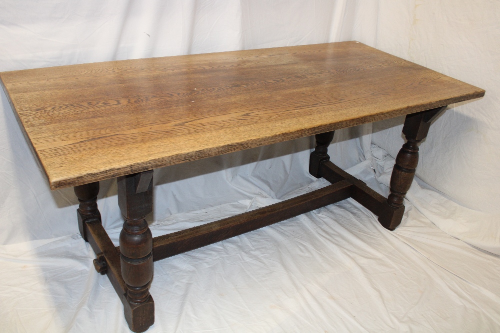 An oak rectangular refectory-style dining table on baluster-shaped supports,