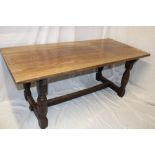 An oak rectangular refectory-style dining table on baluster-shaped supports,
