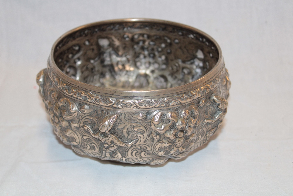 A Persian silvered circular bowl decorated in relief with scrolls and figures 6½" diameter