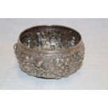 A Persian silvered circular bowl decorated in relief with scrolls and figures 6½" diameter