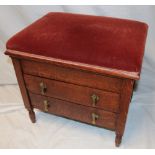A 1920/30s piano stool with hinged upholstered seat above two drawers with folding music fronts on