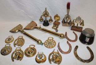 Two old brass horse singeing combs, a selection of various horse brasses, horse harness bells,