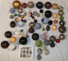 A selection of various polished stone eggs and spheres together with ceramic spheres and others etc.