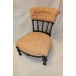 A Victorian ebonised occasional chair with upholstered seat and back on turned legs