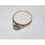 An 18ct gold engagement ring with platinum shoulders set a single diamond (1.