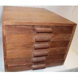 A polished camphor wood collector's chest of six shallow drawers, each with glass protective covers,