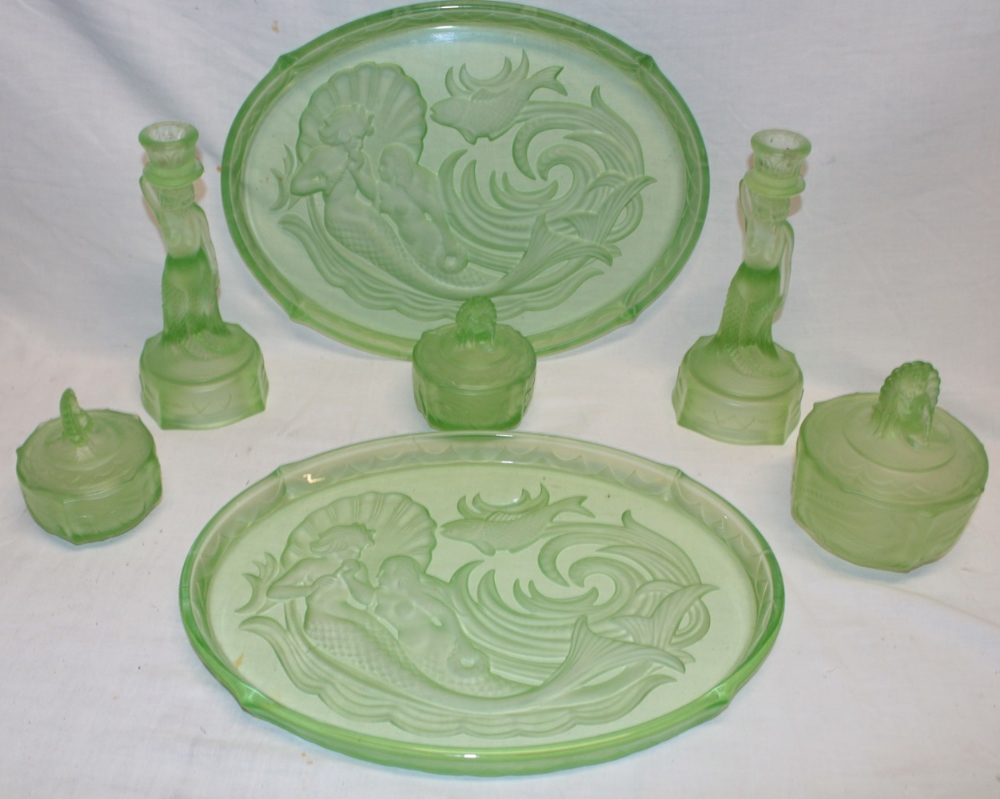 A good quality green tinted glass dressing table set comprising a pair of oval trays decorated with