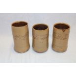 Three Wenford Bridge studio pottery cylindrical vases by Seth Cardew with wavy line decoration on