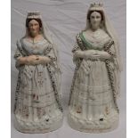 Two 19th century Staffordshire pottery figures "Queen of England" with varying colours and styles,