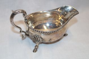 A late Victorian silver classical-shaped sauce boat with decorated edge,